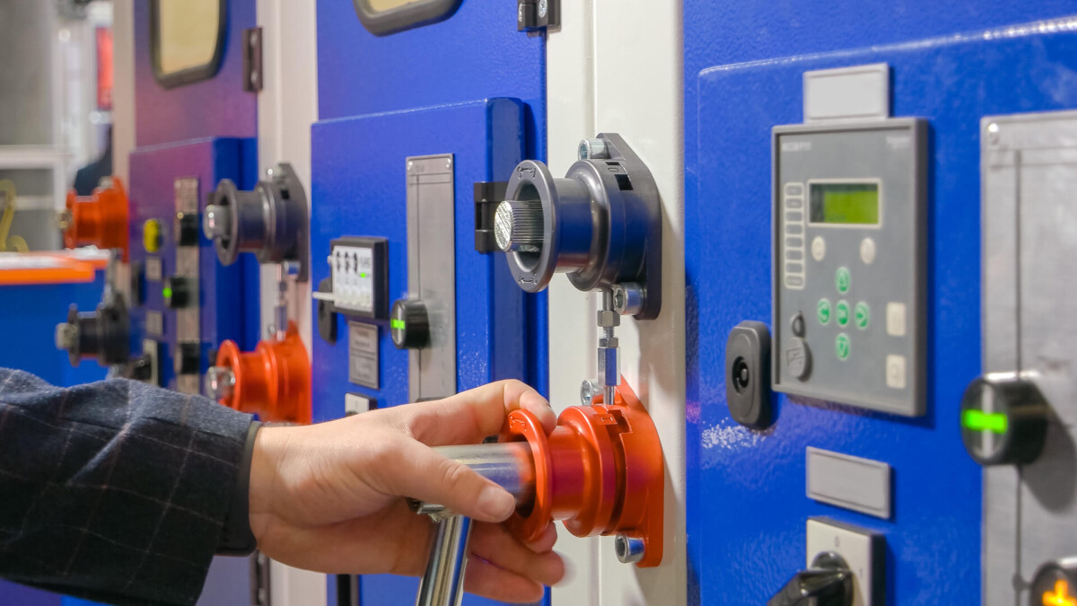 closeup of hand operating machine control panel